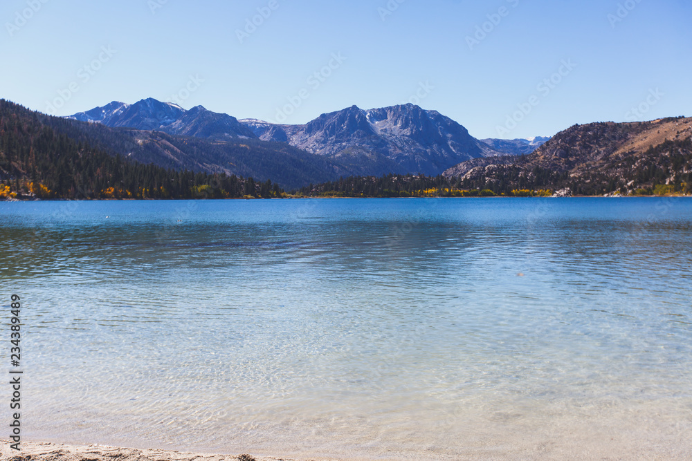 Obraz premium Beautiful vibrant panoramic view of June Lake, Mono County, California, with Mountains of Sierra Nevada and Carson Peak in the background, United States
