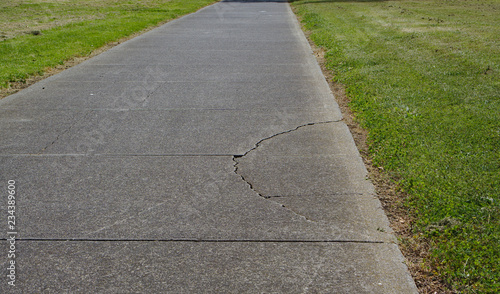 Cracked asphalt on walking path