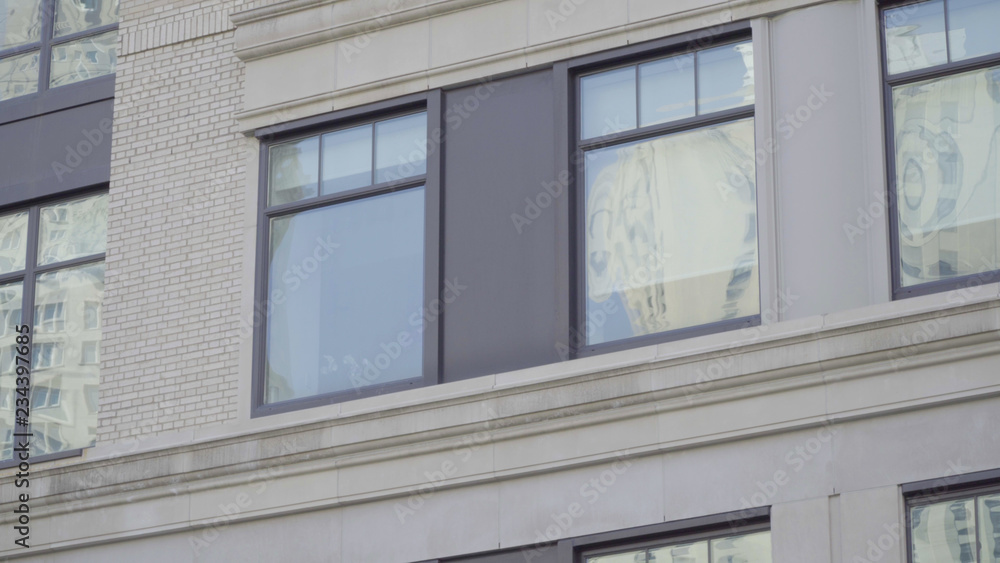 Tight establishing photo of a white brick office or apartment building in New York City. Typical generic day DX exterior scene Tight establishing photo of a white brick office or apartment building in New York City. Typical generic day DX exterior scene