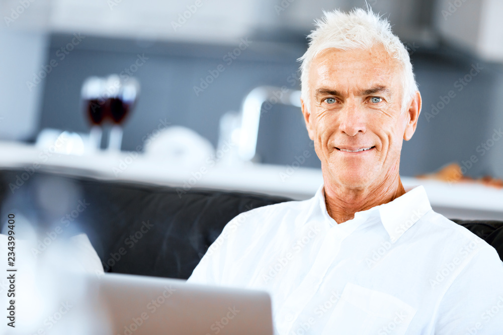 Man working on laptop at home Man working on laptop at home