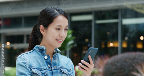 Photography Woman send sms on cellphone