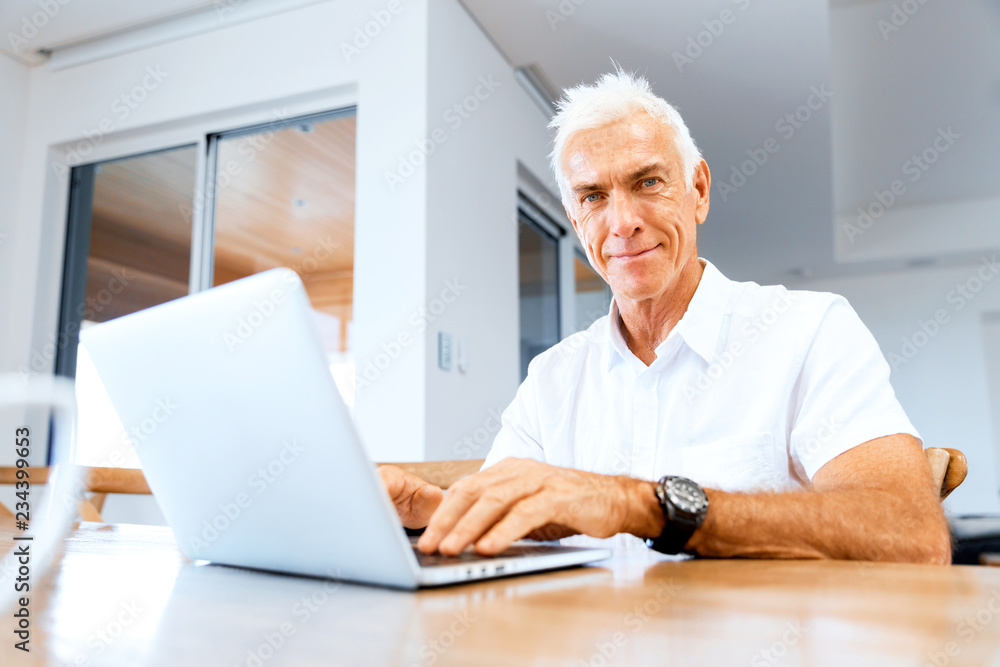 Man working on laptop at home Man working on laptop at home