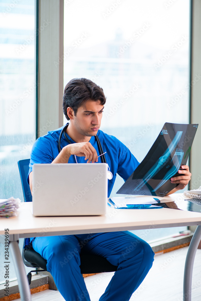 Young handsome doctor working in the hospital Young handsome doctor working in the hospital