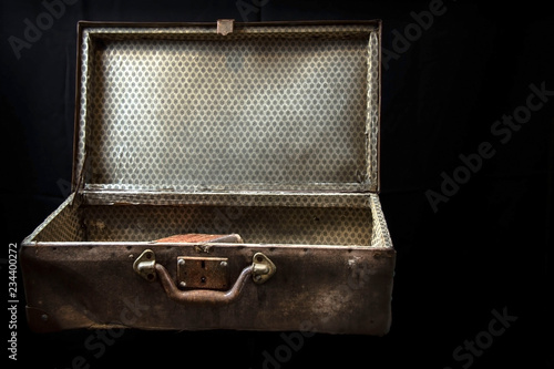 Very old suitcase isolated on black