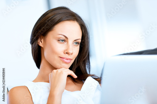 Young beautiful woman working on her laptop