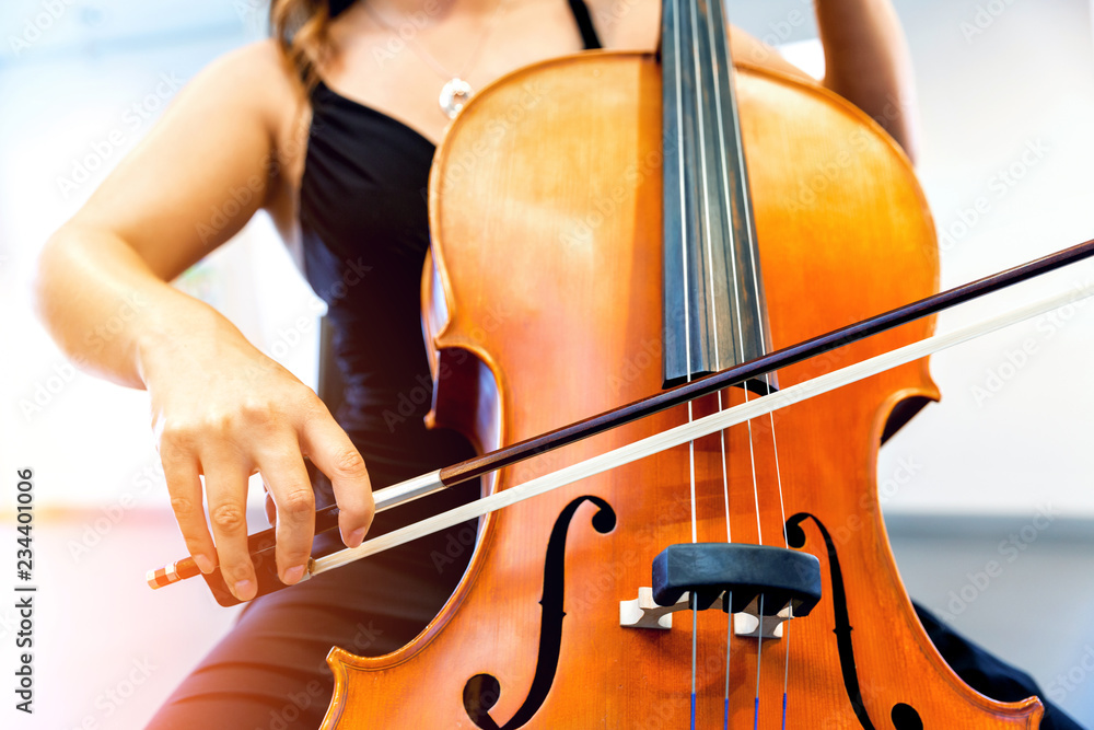 Close up of cello with bow in hands Close up of cello with bow in hands
