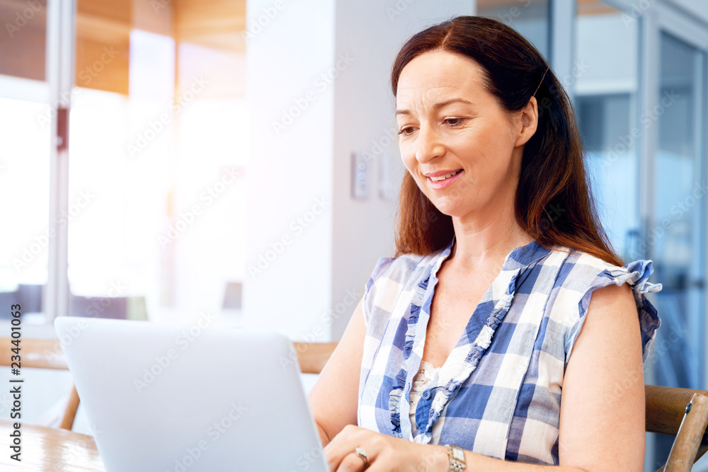 Mature beautiful woman working on her laptop Mature beautiful woman working on her laptop