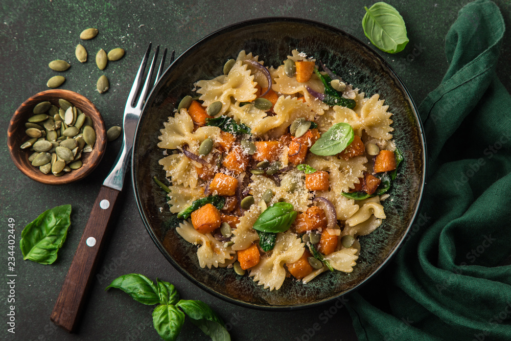 pumpkin farfalle pasta with pumpkin seeds and cheese in bowl pumpkin farfalle pasta with pumpkin seeds and cheese in bowl