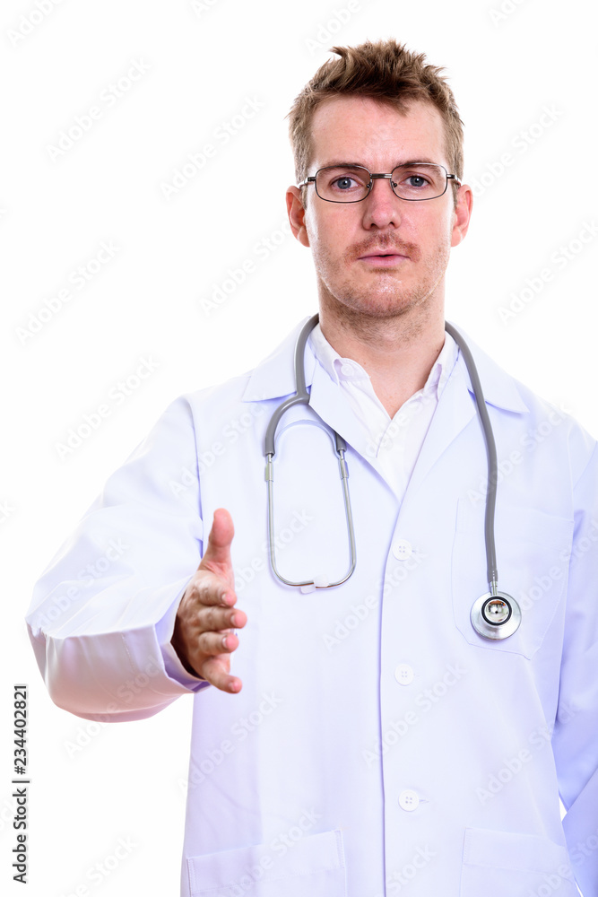 Studio shot of man doctor giving handshake Studio shot of man doctor giving handshake