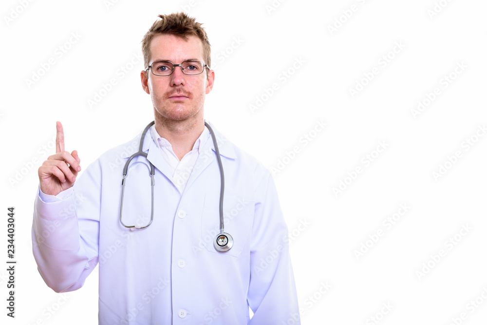 Studio shot of man doctor pointing finger up Studio shot of man doctor pointing finger up