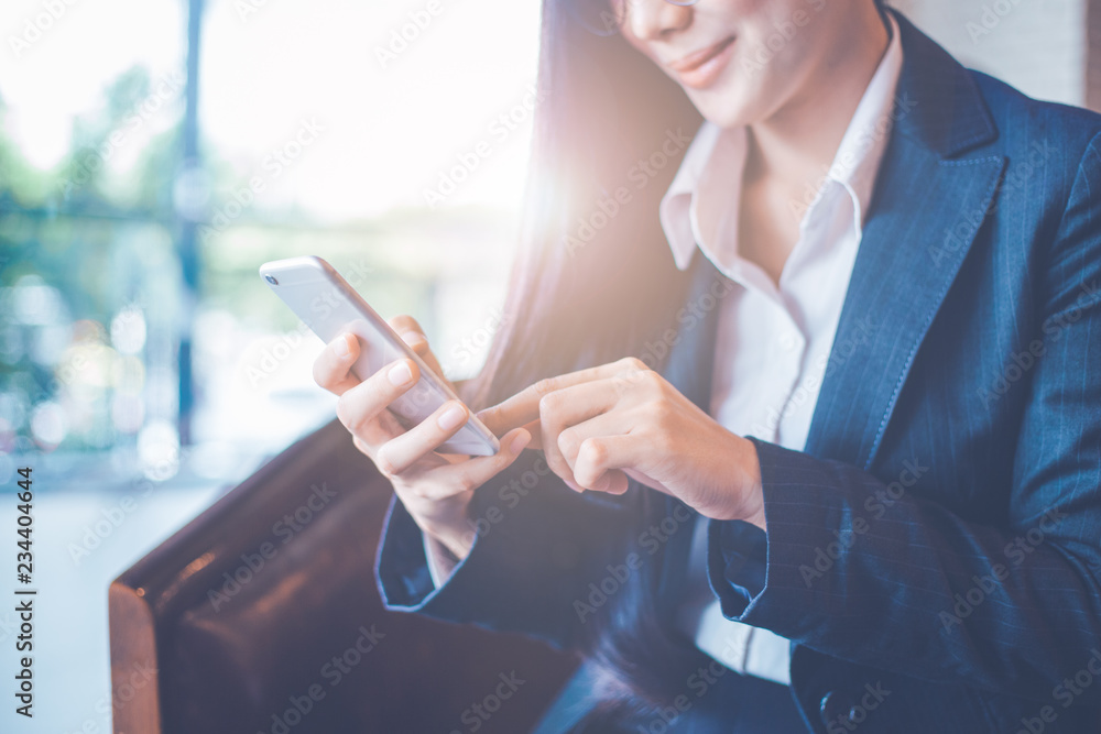 Business women hand are uses a smartphone in office.