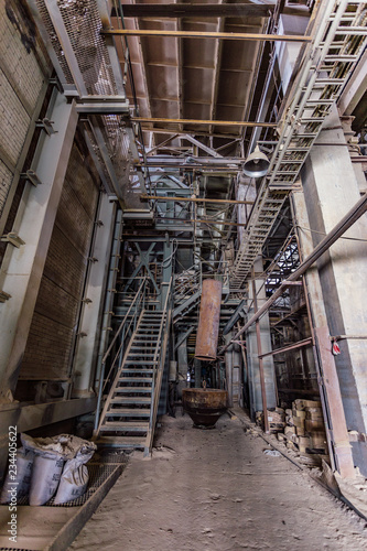 Inside of old abandoned factory. Rusty ruined industrial equipment 