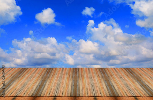 Empty top wooden table on sky background