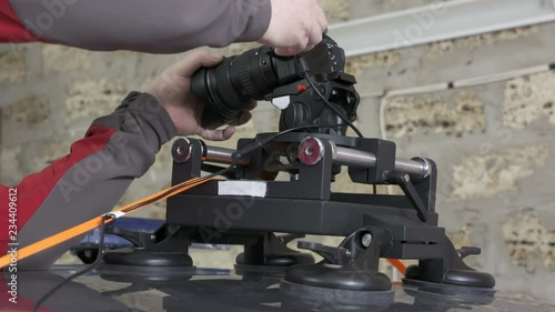 DSLR car suction cup camera mount for shooting on a moving vehicle. Mounting professional video equipment on top of police car.