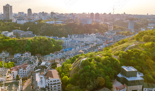 Aerial top view of Kyiv cityscape of Vozdvizhenka and Podol historical districts on sunset from above, city of Kiev, Ukraine
 photo