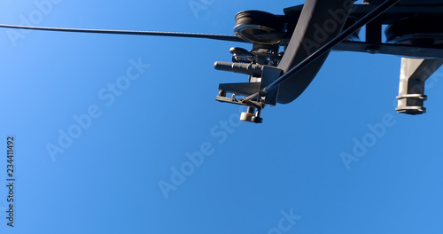 Gondola lift and cable car on blue sky backgroud. This aerial link system transports people to mountain ski slopes. Funicular for tourists, transportation concept