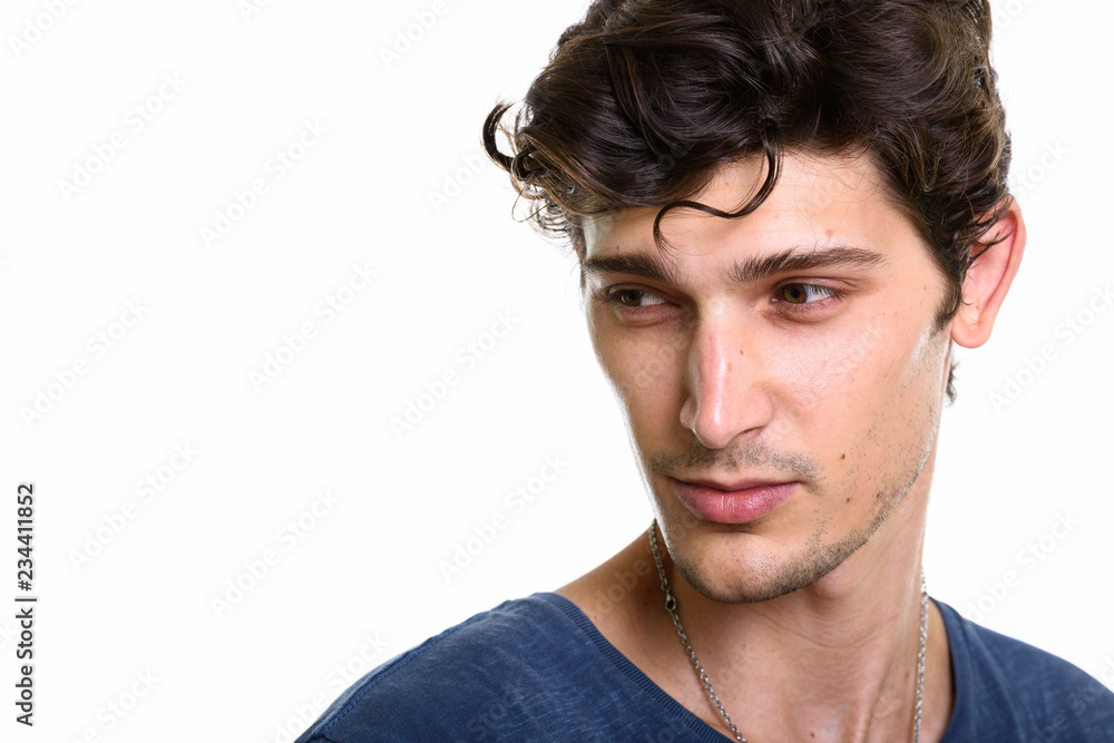 Close up of young handsome man thinking while looking down Close up of young handsome man thinking while looking down