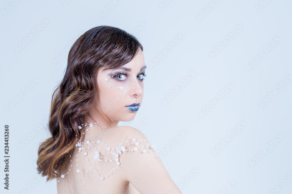 Card calendar. Girl's Face.Creative Winter Makeup.beautiful attractive girl with fantasy make up and hair style isolated on white background.Girl with Snow Hair style and Holiday Makeup.Winter and ice