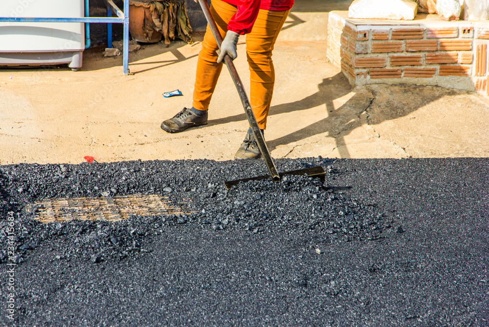 workers are leveling asphalt on construction site. workers are leveling asphalt on construction site.
