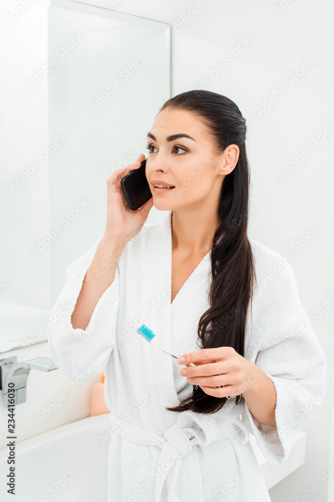 attractive woman with toothbrush talking on smartphone attractive woman with toothbrush talking on smartphone