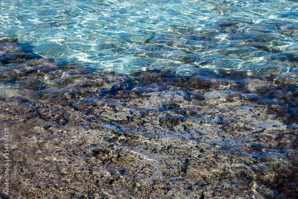 clear water of Mediterranean with stone and sandy bottom