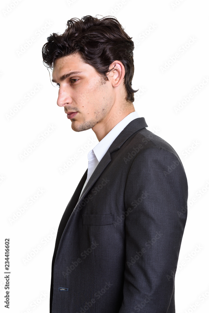 Profile view of young handsome Hispanic businessman Profile view of young handsome Hispanic businessman