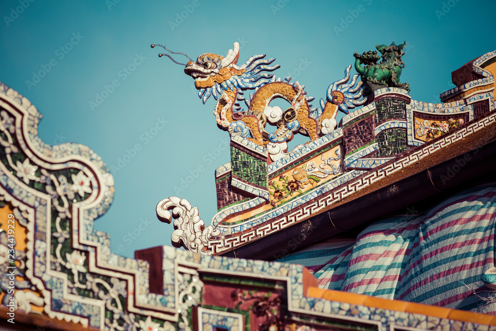 Detailed view of dragons on Citadel the Imperial City with the Purple Forbidden City in Hue, Vietnam.