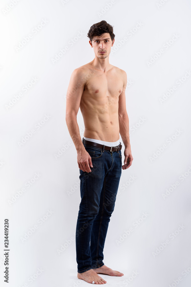 Foto Stock Full body shot of young handsome man standing on right side shir  | Adobe Stock