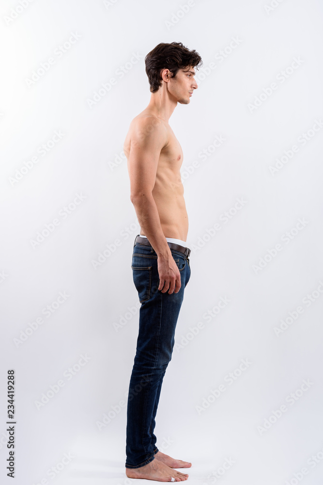 Full body shot of profile view of young handsome man standing sh Stock  Photo