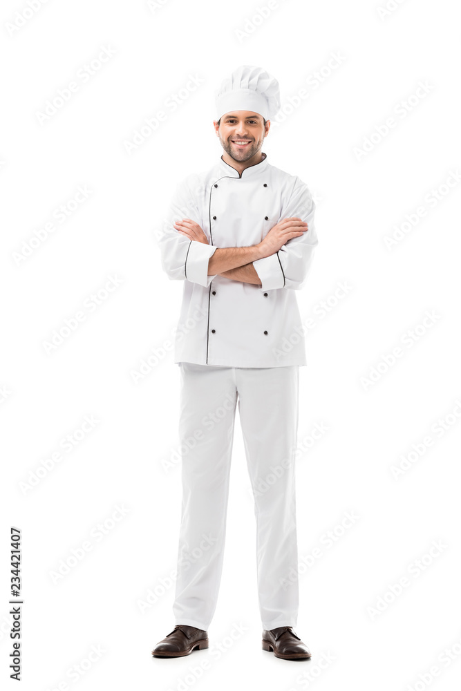 happy young chef with crossed arms looking at camera isolated on white
