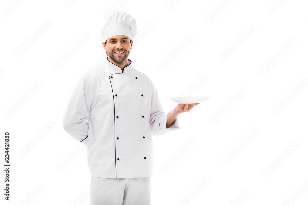 handsome young chef holding empty plate and looking at camera isolated on white handsome young chef holding empty plate and looking at camera isolated on white