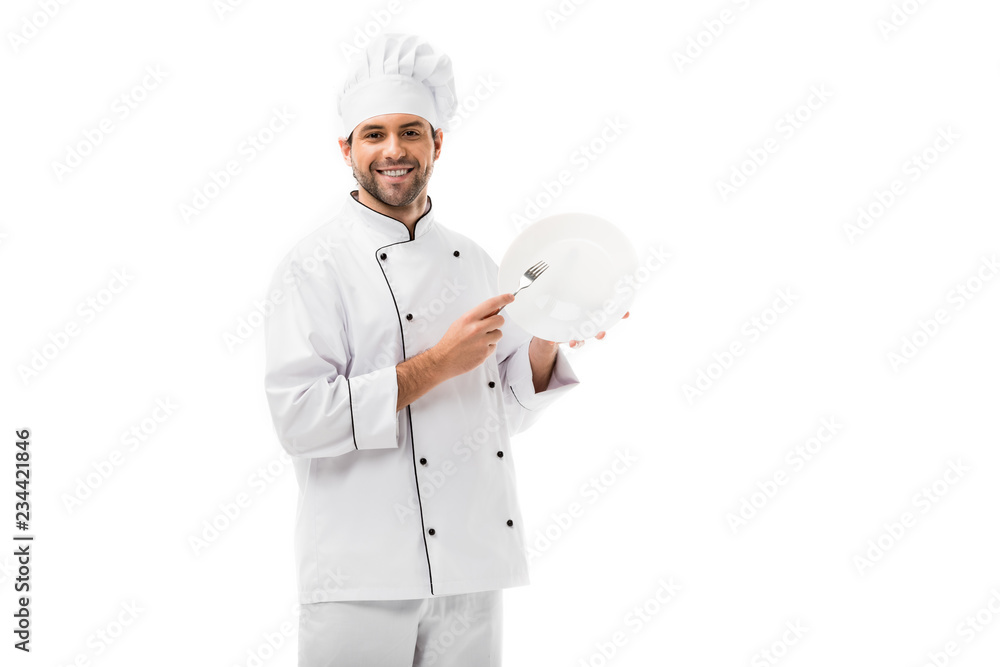 handsome young chef with plate and fork looking at camera isolated on white handsome young chef with plate and fork looking at camera isolated on white