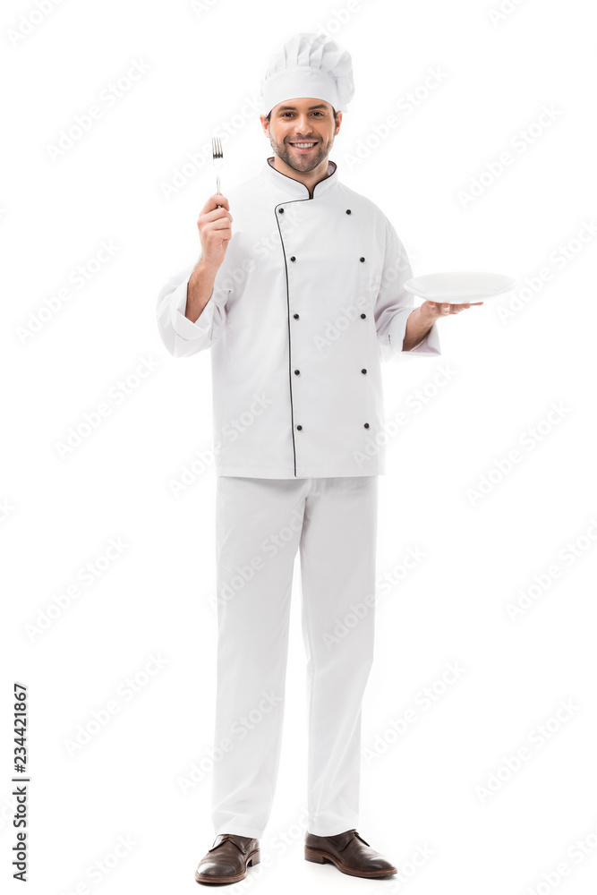 happy young chef with plate and fork looking at camera isolated on white happy young chef with plate and fork looking at camera isolated on white