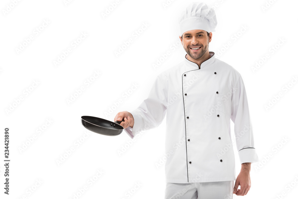 smiling young chef holding frying pan and looking at camera isolated on white smiling young chef holding frying pan and looking at camera isolated on white