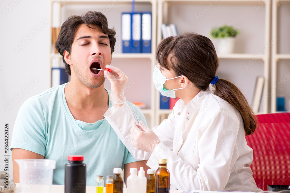 Young handsome man visiting female doctor dentist for removal of Young handsome man visiting female doctor dentist for removal of
