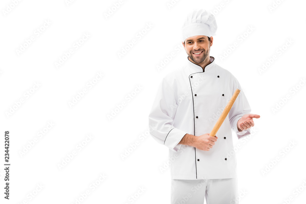 smiling young chef holding rolling pin and looking away isolated on white