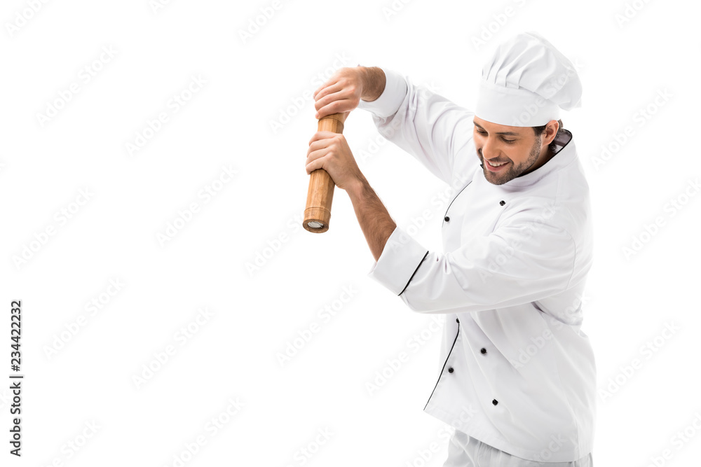 smiling young chef with bamboo pepper mill isolated on white smiling young chef with bamboo pepper mill isolated on white