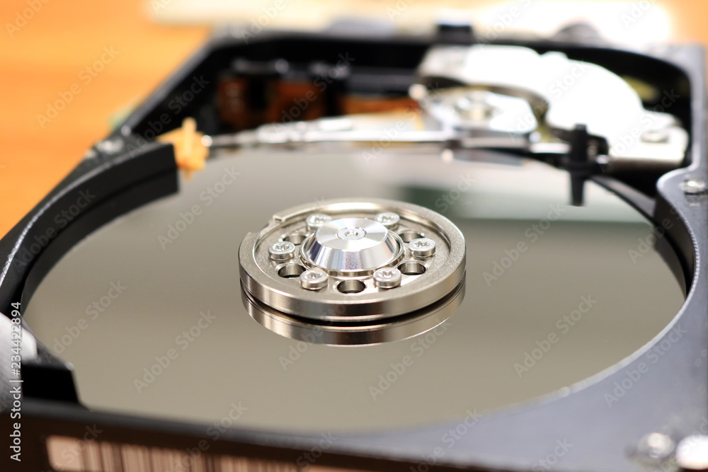 Open inside harddisk disassembled from the computer. Closeup magnetic tape in hard drive. Open inside harddisk disassembled from the computer. Closeup magnetic tape in hard drive.