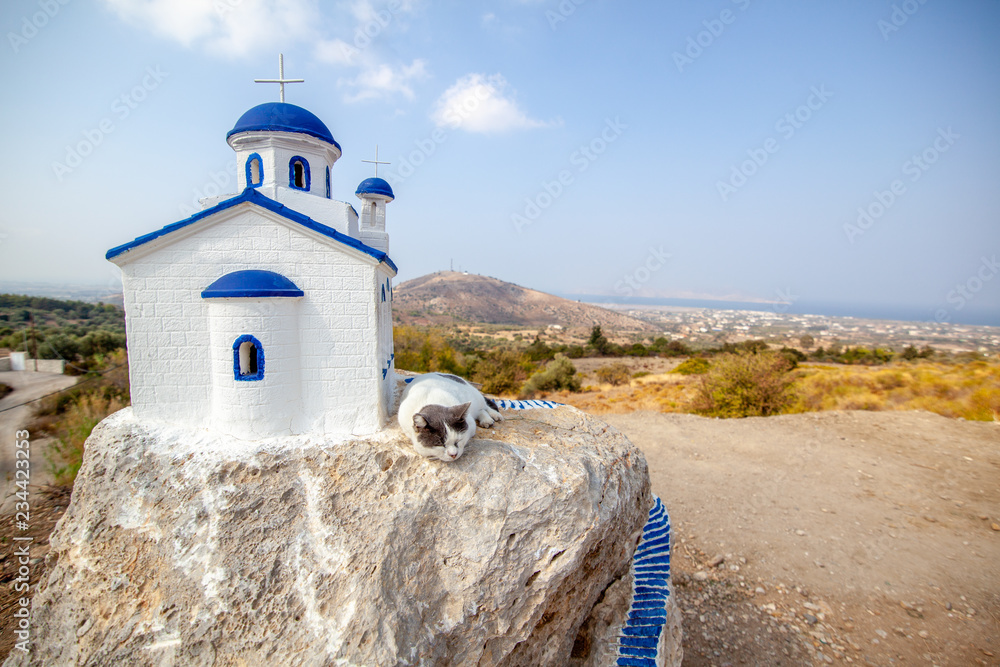 Kos island Zia village, The cat sleeps on a miniature version of an Orthodox church.