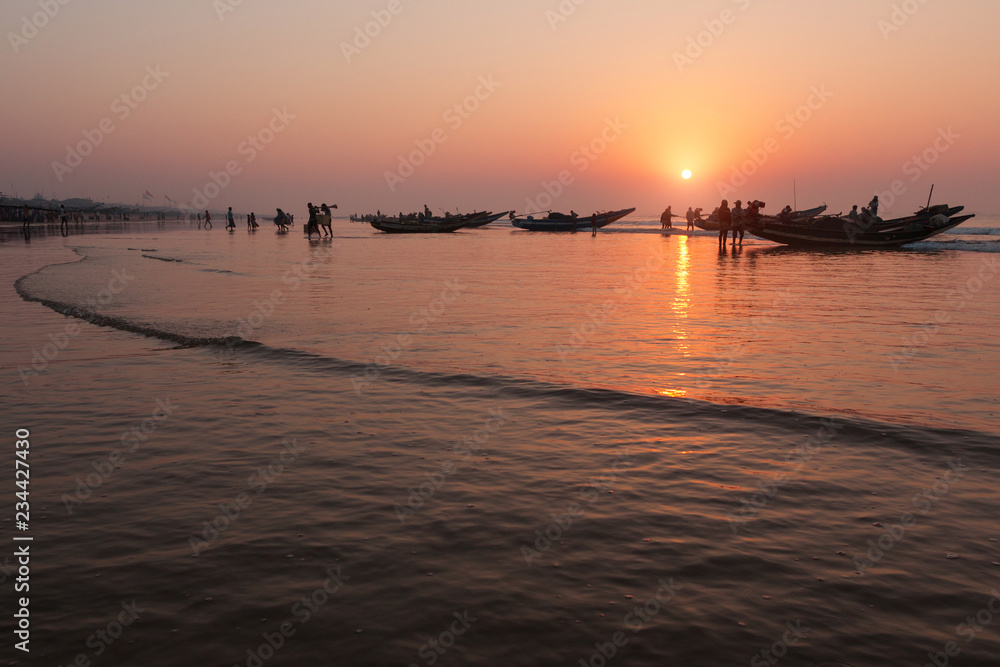 Indian fishermen are back in boats with their catch, early morning, red dawn, Indian Ocean
