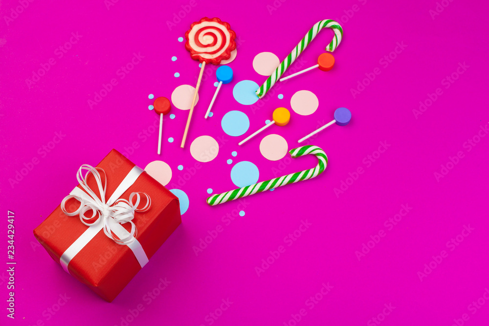 Box with splashed confetti of ribbon, dudes and other festive accessories