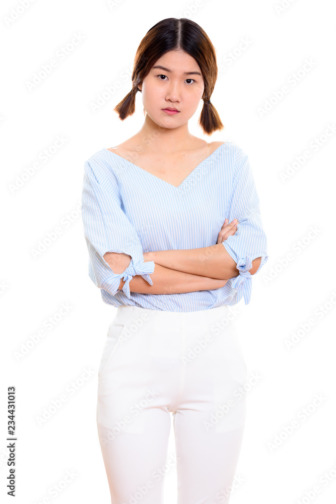Studio shot of young beautiful Asian woman standing with arms cr Studio shot of young beautiful Asian woman standing with arms cr