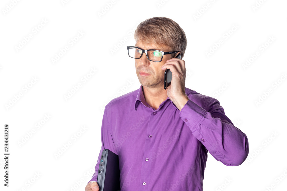 Portrait of middle aged guy holding a laptop and talking on mobile phone over white background Portrait of middle aged guy holding a laptop and talking on mobile phone over white background