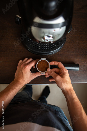 Image of coffee maker, man hand pouring coffee