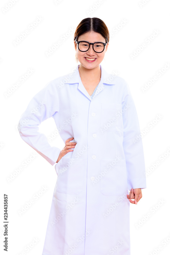 Studio shot of young happy Asian woman doctor smiling with hand Studio shot of young happy Asian woman doctor smiling with hand