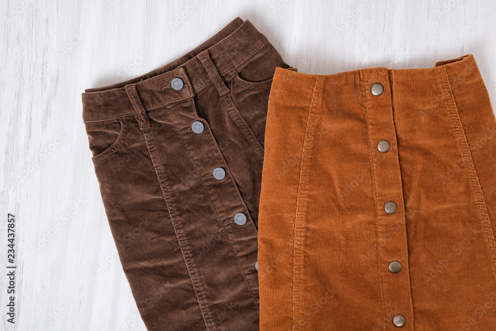 Two brown skirts on a wooden background. Fashion concept Two brown skirts on a wooden background. Fashion concept