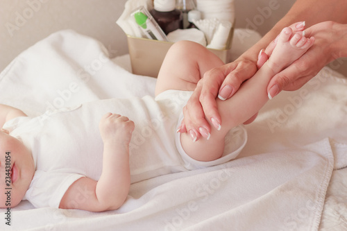 Baby and hands of mother, soft focus background