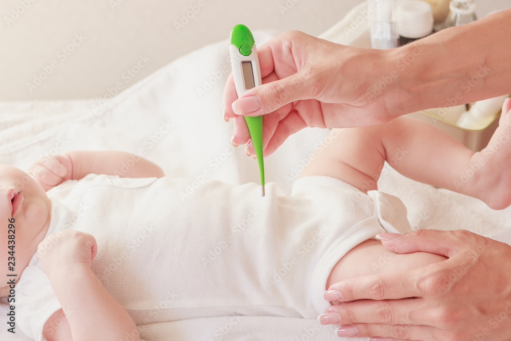 Baby and hands of mother, soft focus background Baby and hands of mother, soft focus background
