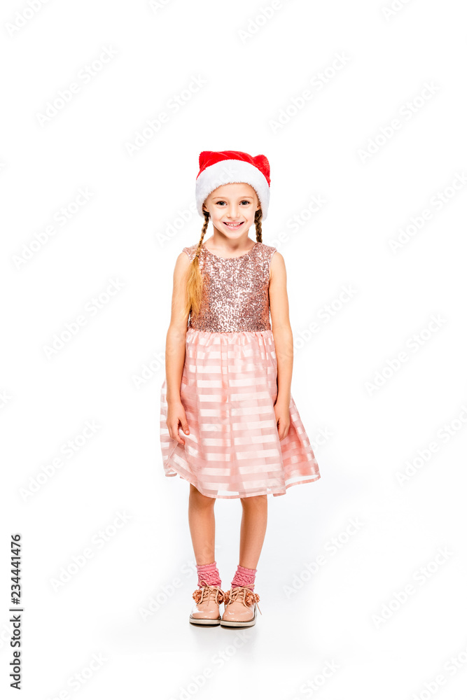 adorable little child in santa hat and dress looking at camera isolated on white adorable little child in santa hat and dress looking at camera isolated on white