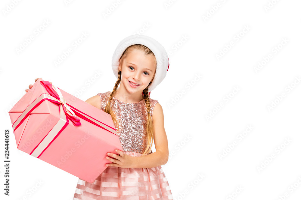 adorable little child in santa hat holding gift box and looking at camera isolated on white adorable little child in santa hat holding gift box and looking at camera isolated on white